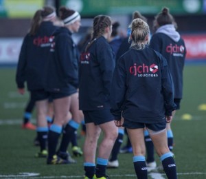 Cardiff blues womens team sporting their wet weather kit as part of sponsorship package from CJCH solicitors